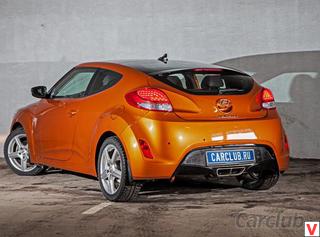 Яркий образ Veloster сформирован множеством интересных решений: большой крышкой багажника с заходящим глубоко на крышу стеклом, массивными колесными арками, центрально расположенным патрубком выхлопной системы и выштампованными бумерангами на боках.